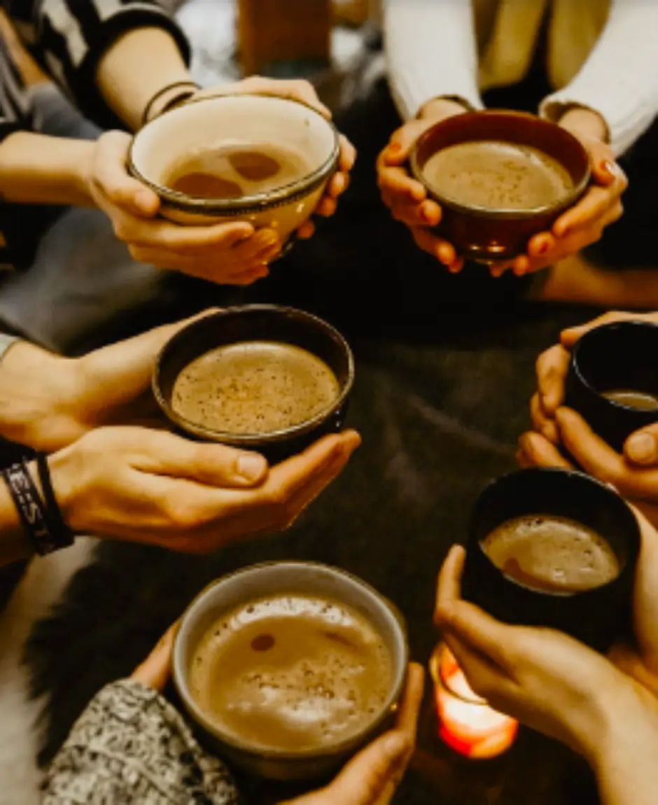 hands holding cups of cacao